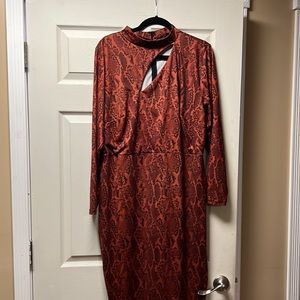 Sleek and sexy body con dress with chest cut out!  Snake pattern fabric size 20